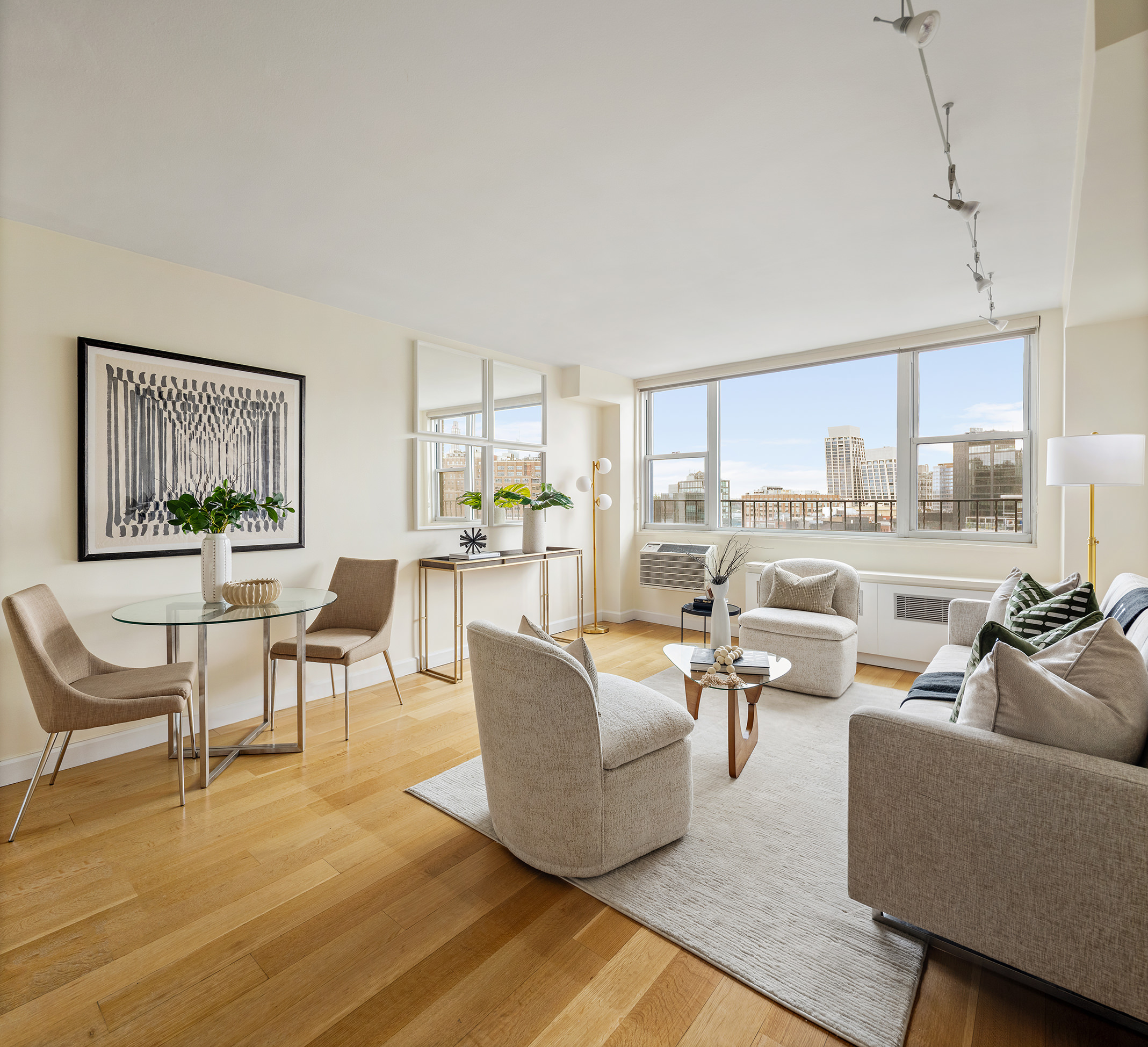 61 Jane Street, Unit 19J Manhattan, NY 10014 - Photo 2 of 12 a living room with furniture and a large window