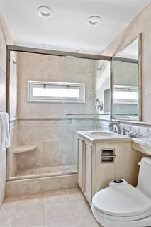 a bathroom with a sink a toilet and mirror