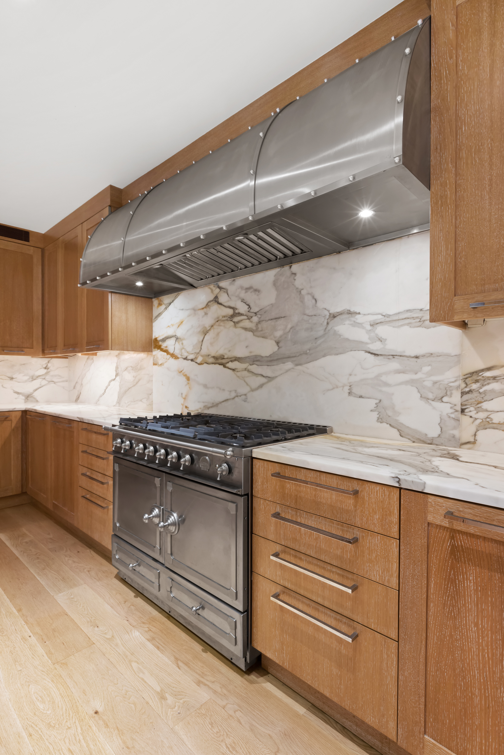 45 East 74th Street Manhattan, NY 10021 - Photo 13 of 33 a kitchen with granite countertop a stove and a cabinets