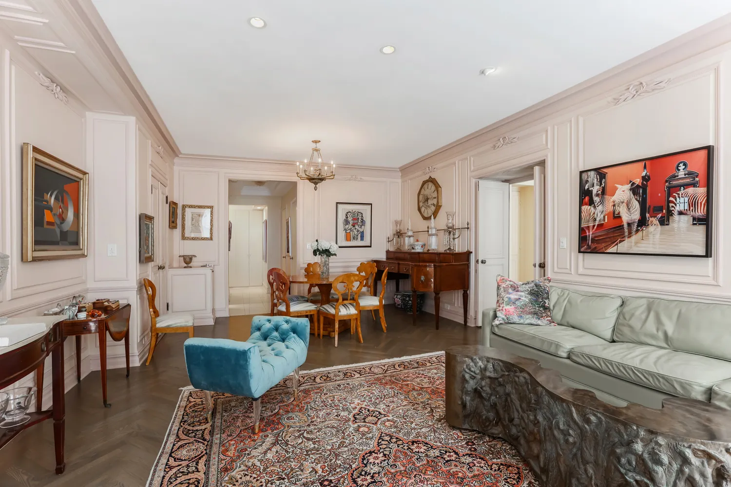a living room with furniture a rug and a painting