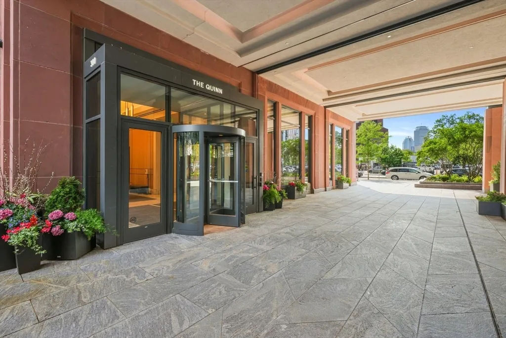 a dining room with furniture and a potted plant