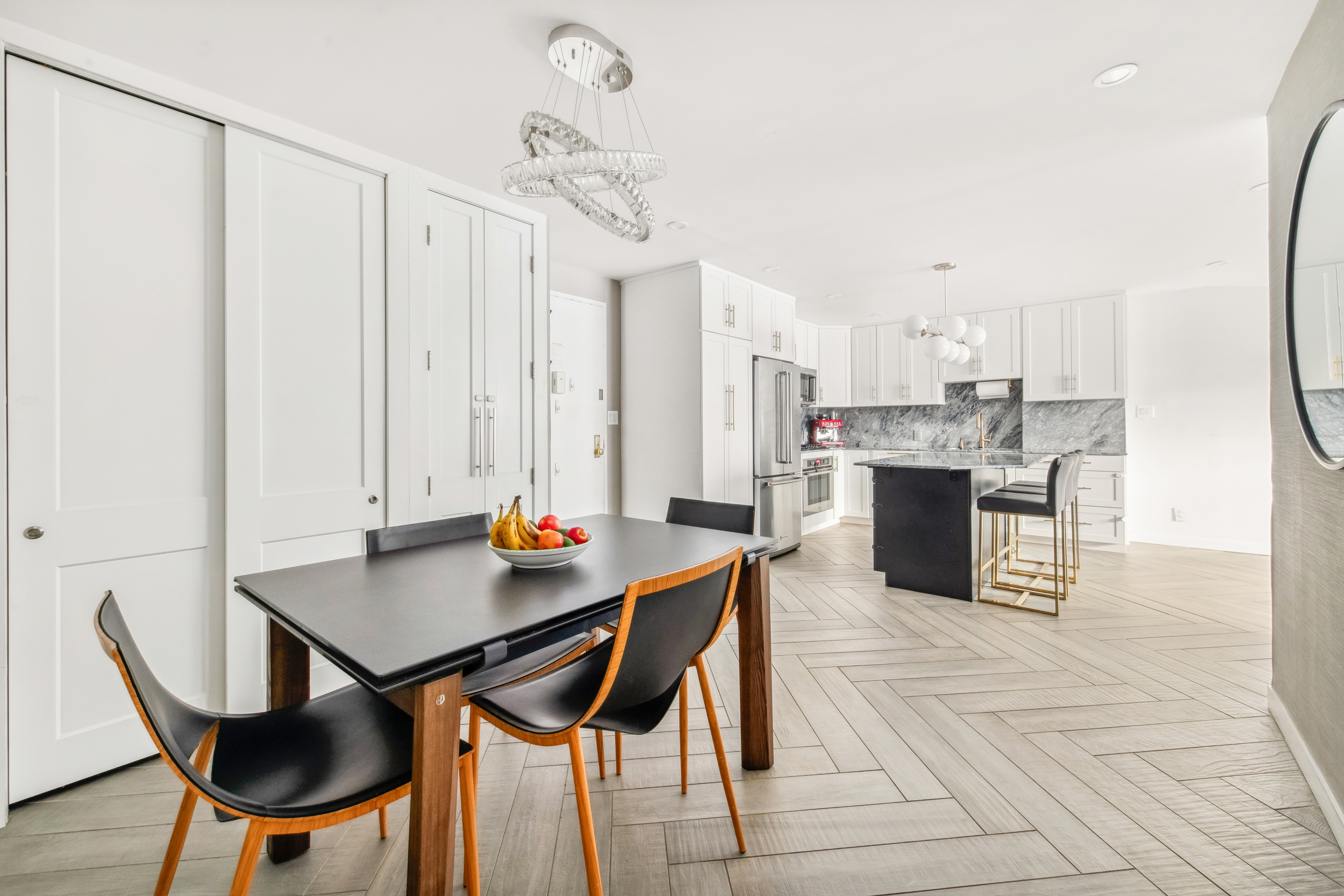 340 East 80th Street, Unit 1D Manhattan, NY 10075 - Photo 6 of 15 a kitchen with stainless steel appliances a table and chairs in it