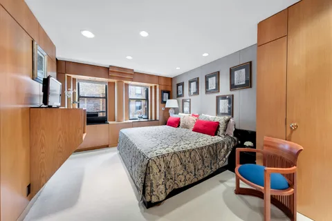 a bedroom with a large bed and a dresser