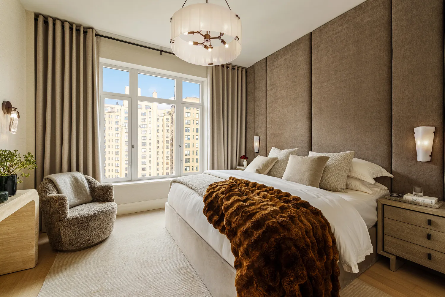 a bed sitting in a spacious bedroom next to a window