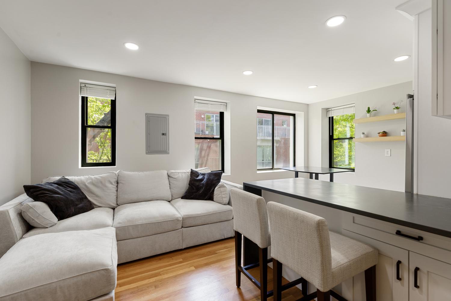 a living room with furniture and a large window