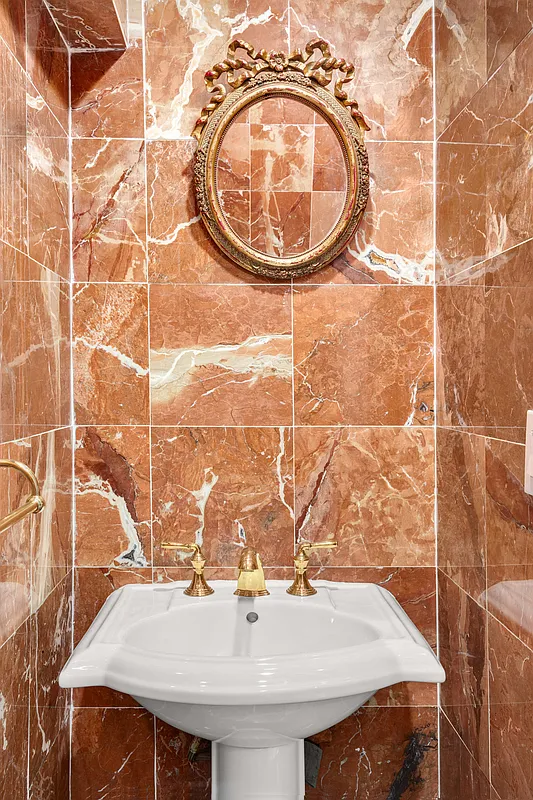 177 East 70th Street Manhattan, NY 10021 - Photo 12 of 14 a bathroom with a sink and a mirror