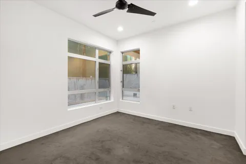 an empty room with a empty space and windows