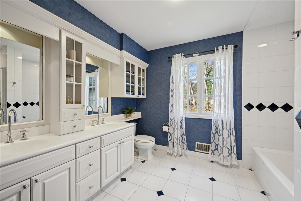 Johnston Drive Watchung, NJ 07069 - Photo 49 of 85 a spacious bathroom with a double vanity sink a toilet and a bathtub