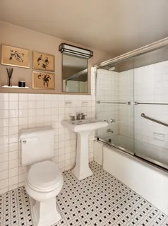 a bathroom with a sink a toilet and a shower