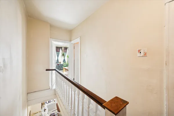a view of a hallway with a window