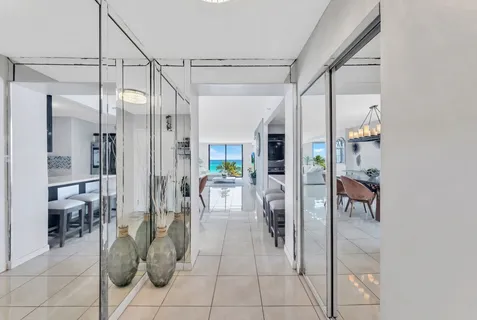 a lobby with furniture and a glass door shower