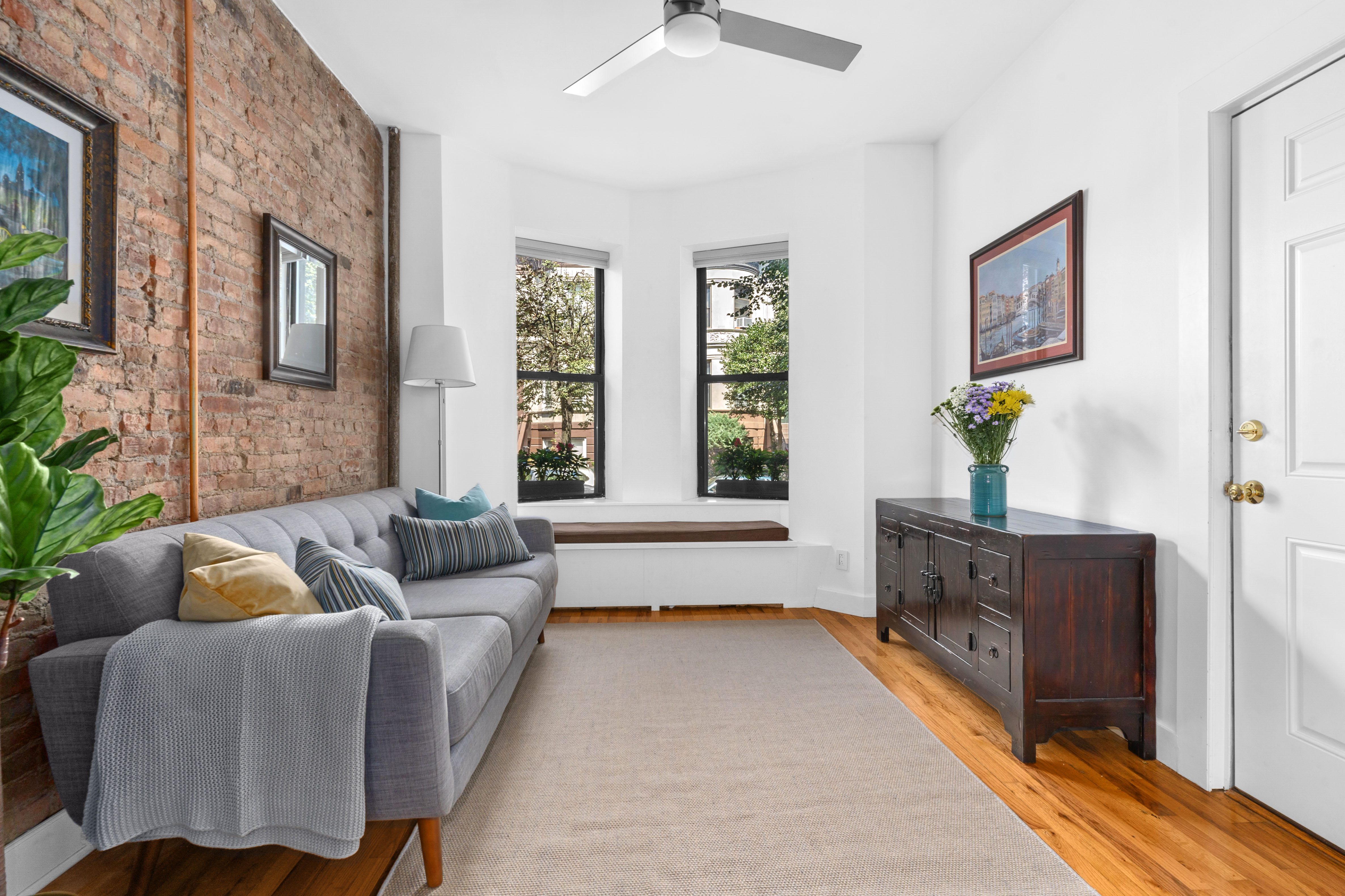 a living room with furniture and wooden floor