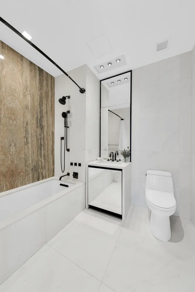 a bathroom with a sink a toilet and a mirror