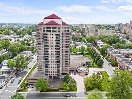 a kitchen with stainless steel appliances granite countertop a stove a sink dishwasher a refrigerator with wooden cabinets and floor