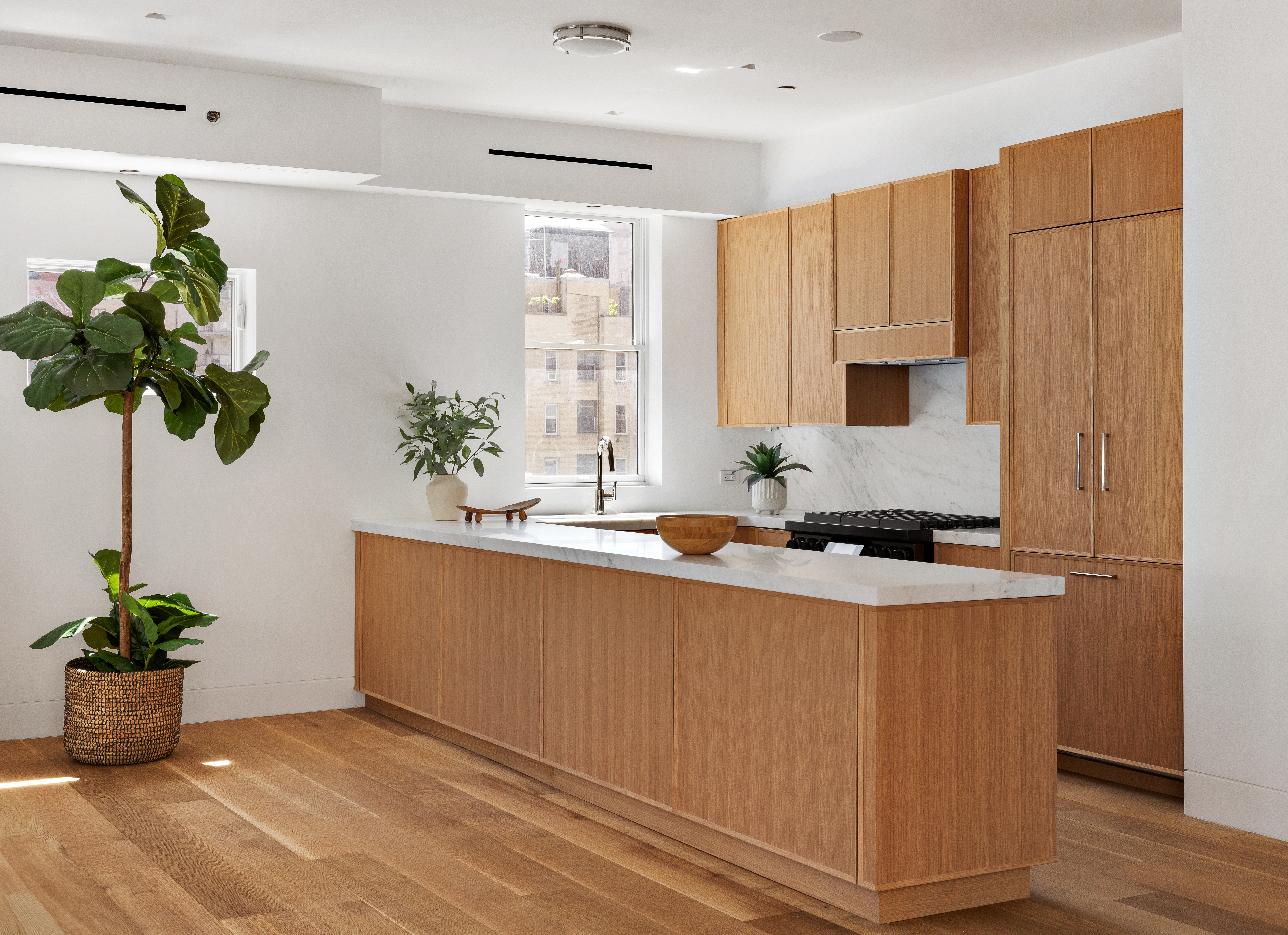 120 East 29th Street, Unit PHB Manhattan, NY 10016 - Photo 3 of 10 a white kitchen with a sink a potted plant and a potted plant