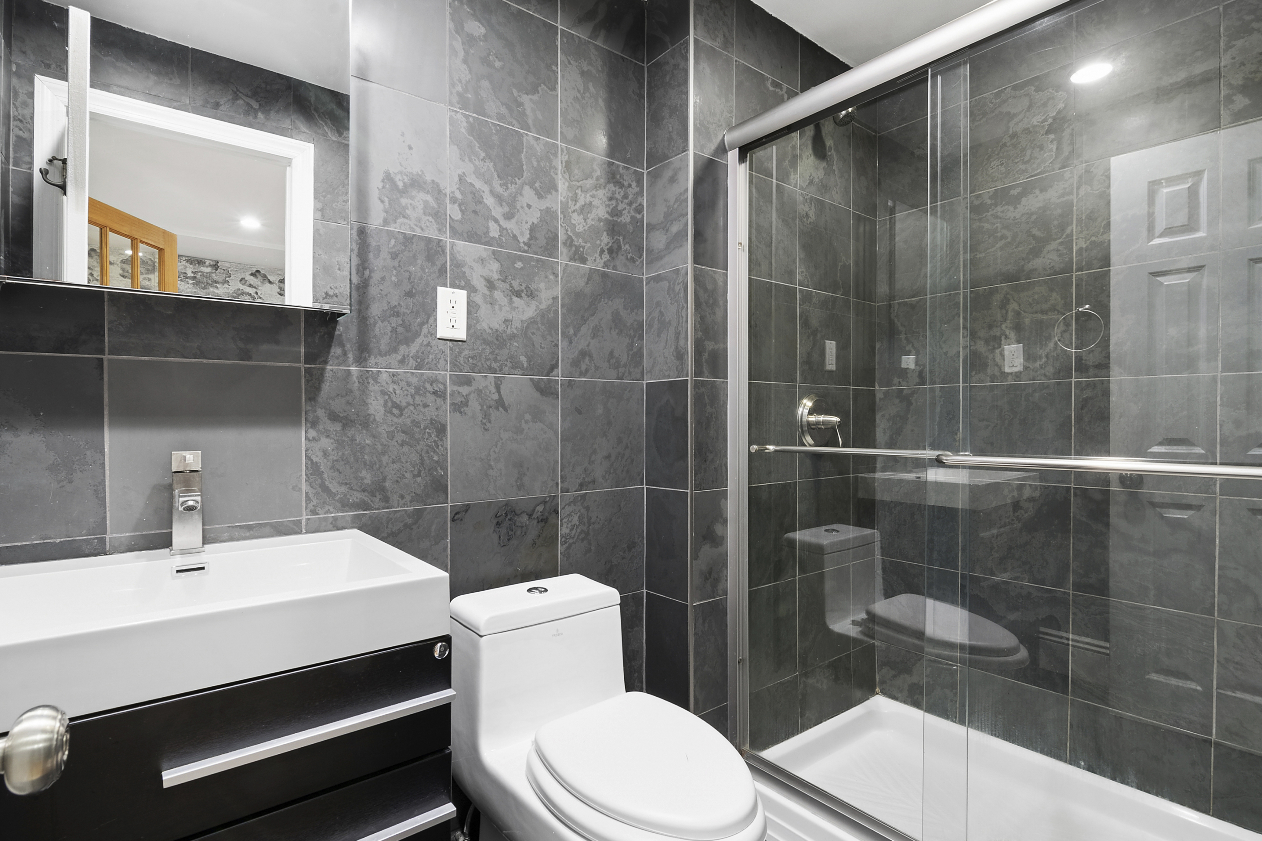 594 6th Avenue, Unit 1 Brooklyn, NY 11215 - Photo 8 of 13 a bathroom with a sink a toilet and shower