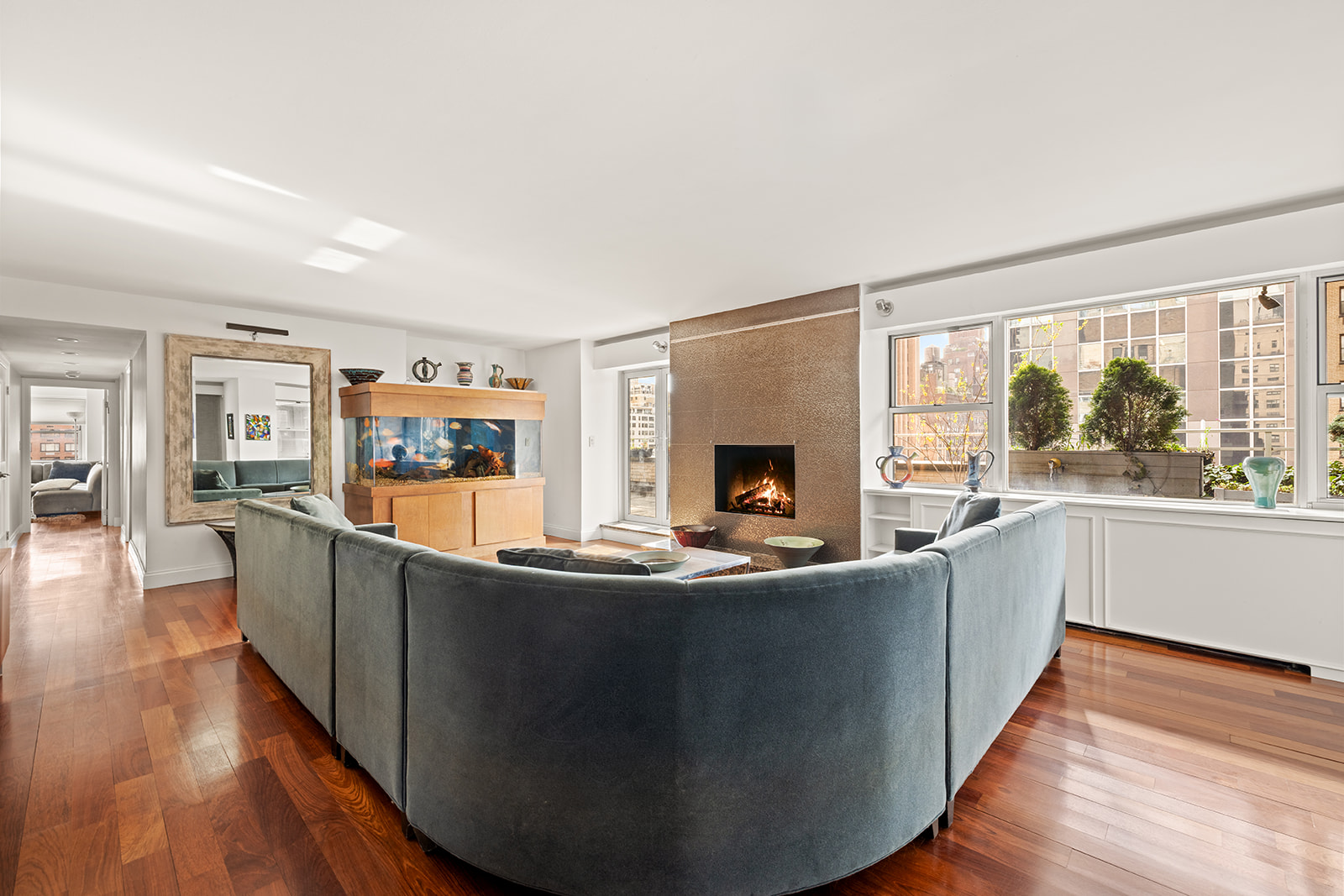 330 East 49th Street, Unit 12EF Manhattan, NY 10017 - Photo 4 of 16 a living room with wooden floor and a fireplace