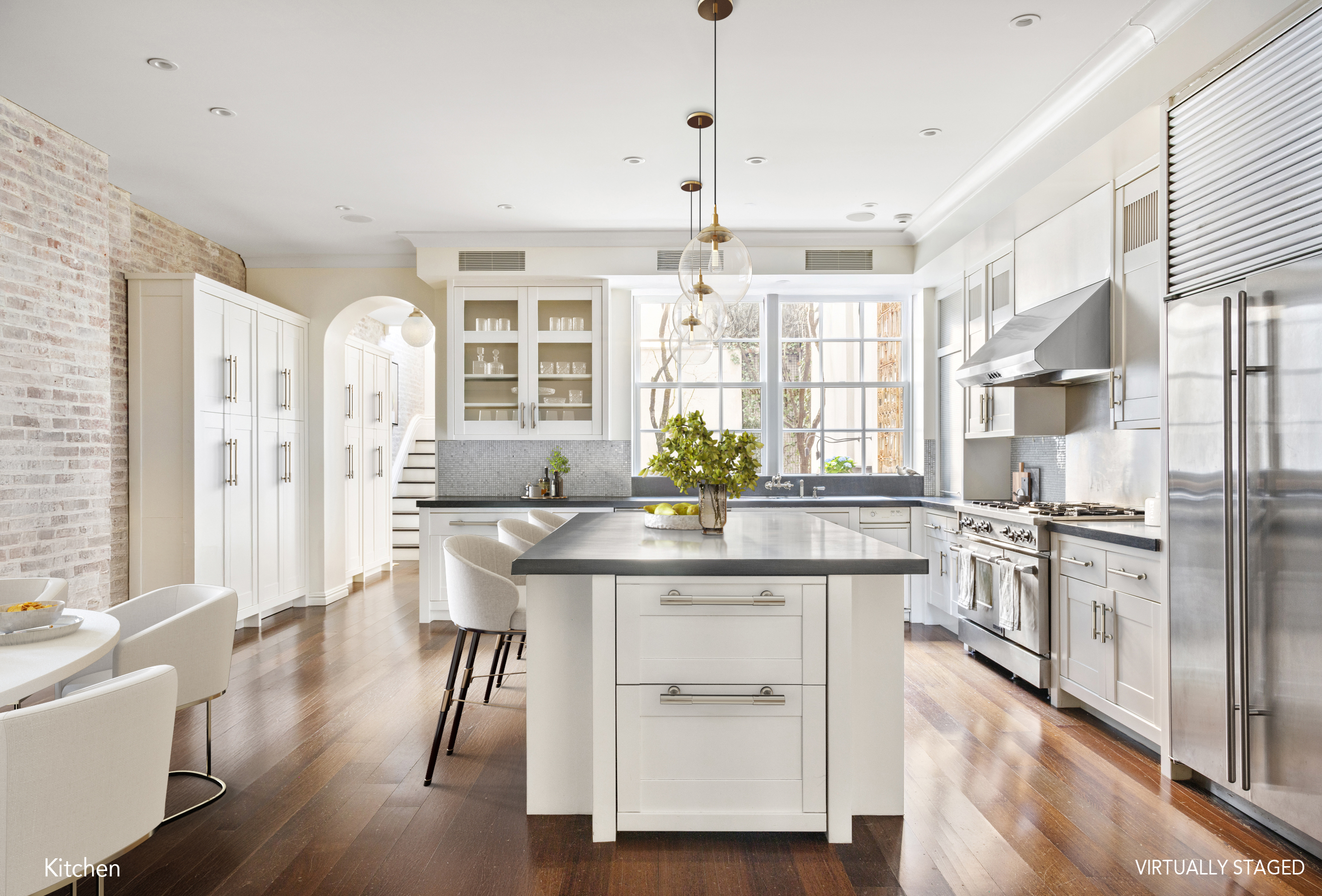 127 East 73rd Street Manhattan, NY 10021 - Photo 7 of 40 a kitchen with stainless steel appliances granite countertop a stove a refrigerator a sink dishwasher with a dining table and chairs with wooden floor
