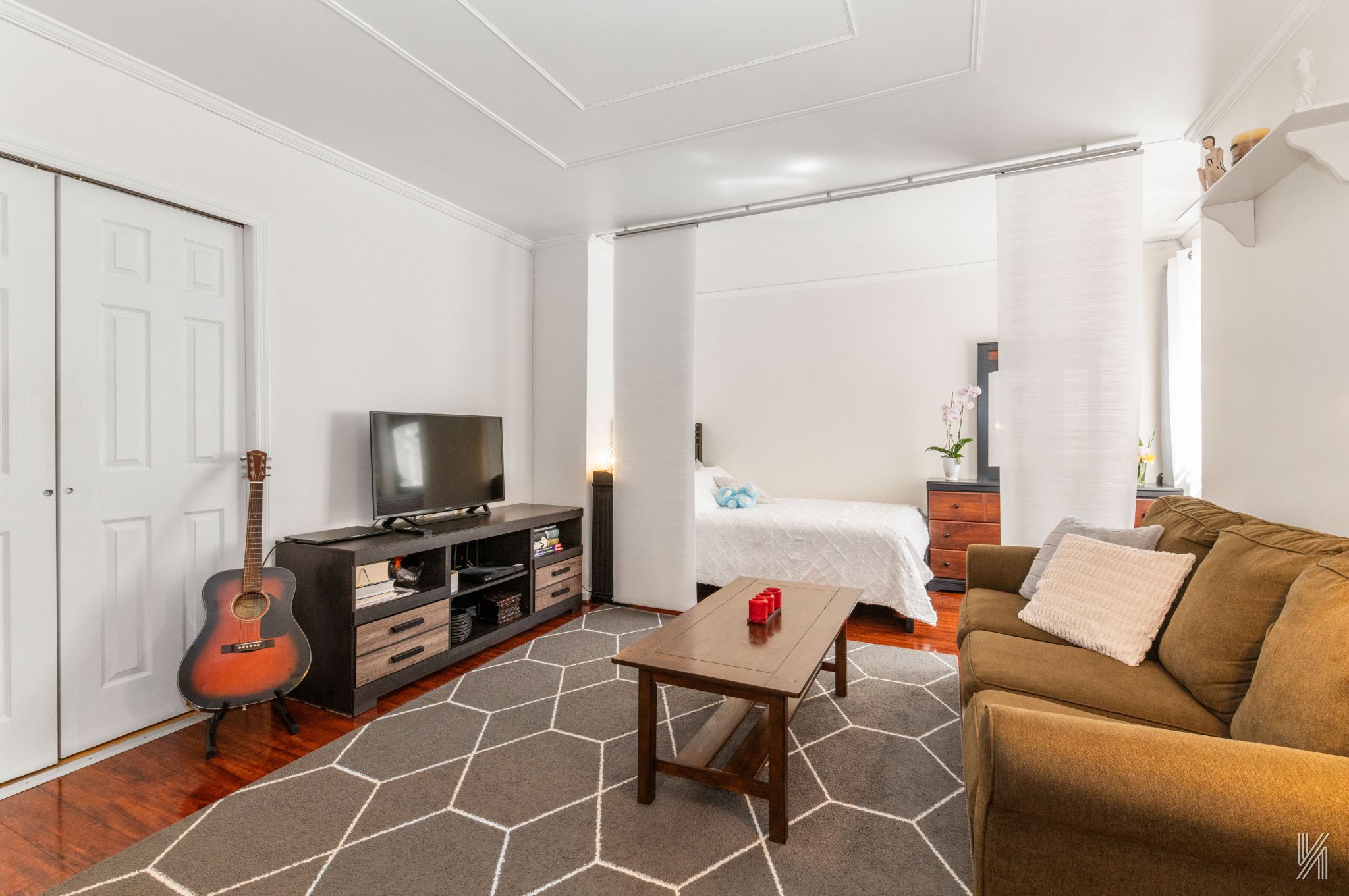 39-30 52nd Street, Unit 5E Queens, NY 11377 - Photo 4 of 15 a living room with furniture and a flat screen tv