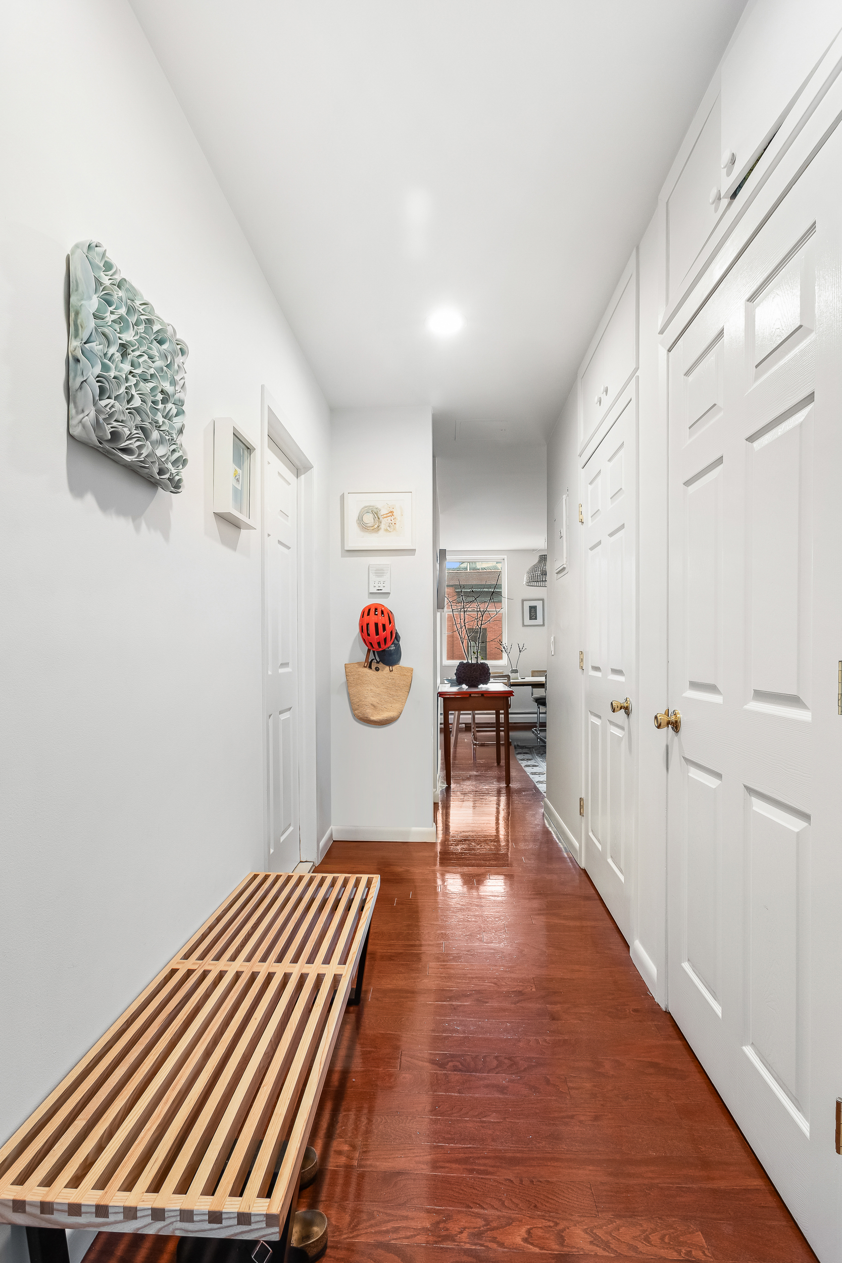 185 Smith Street Brooklyn, NY 11201 - Photo 6 of 14 a view of a hallway with wooden floor and workspace