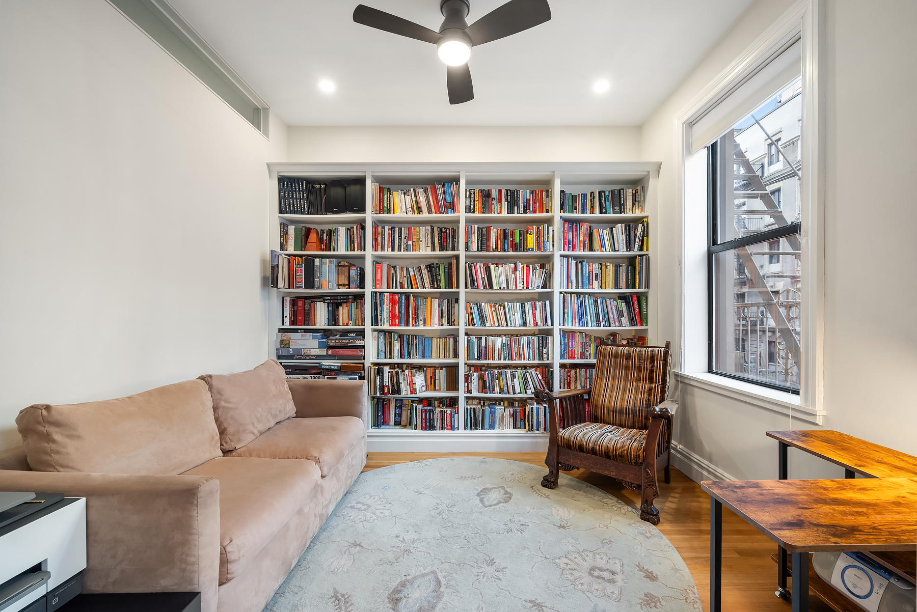 334 West 85th Street, Unit 3A Manhattan, NY 10024 - Photo 6 of 8 a living room with furniture and a book shelf