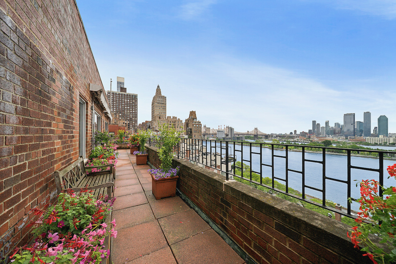 a view of a balcony with wooden benches