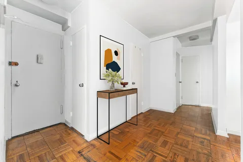 a bedroom with a bed and painting on the wall