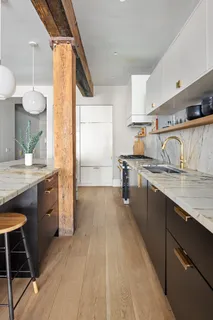 a kitchen with granite countertop a sink stove and cabinets