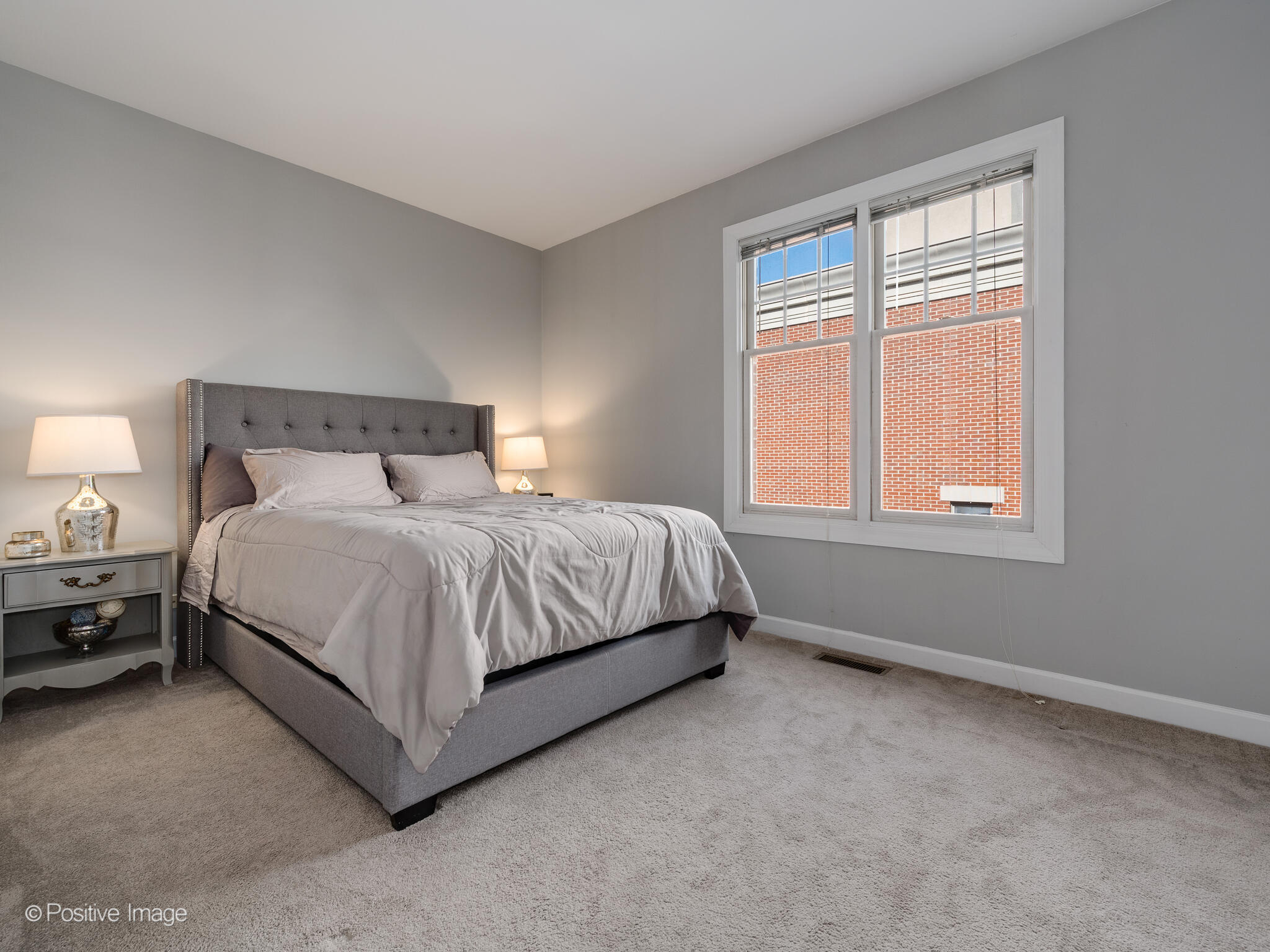 855 North May Street, Unit G Chicago, IL 60642 - Photo 18 of 28 a bedroom with a bed lamp and window