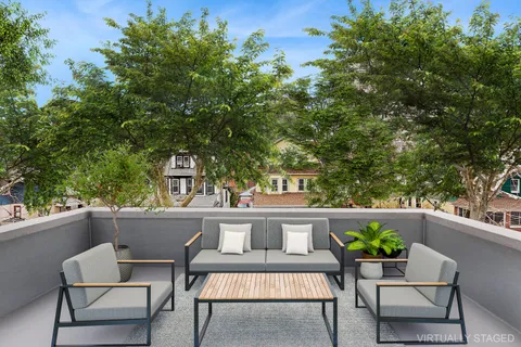 a view of a patio with table and chairs and potted plants