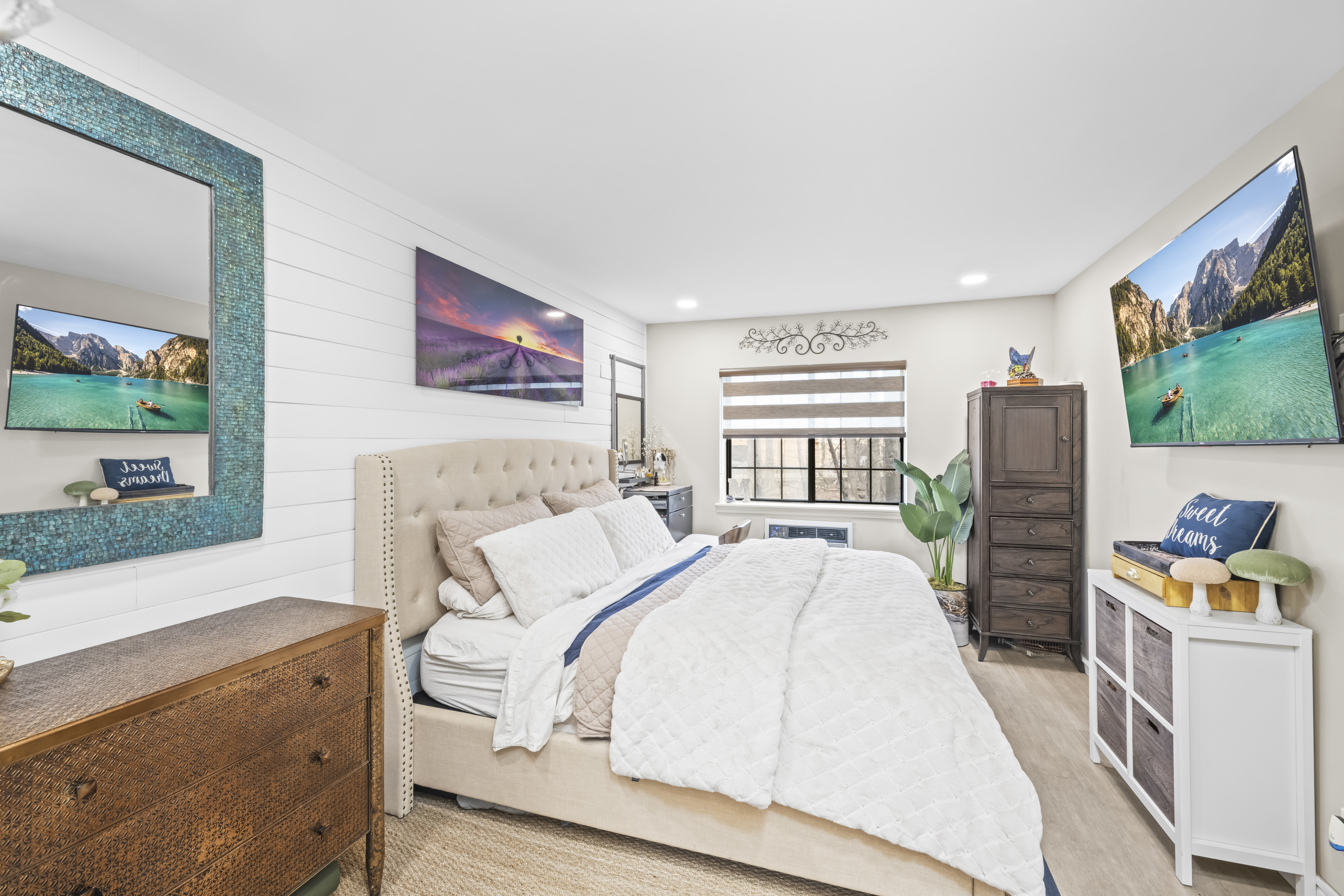 2 Elmwood Park Drive, Unit 209 Staten Island, NY 10314 - Photo 12 of 17 a spacious bedroom with a bed and a flat screen tv