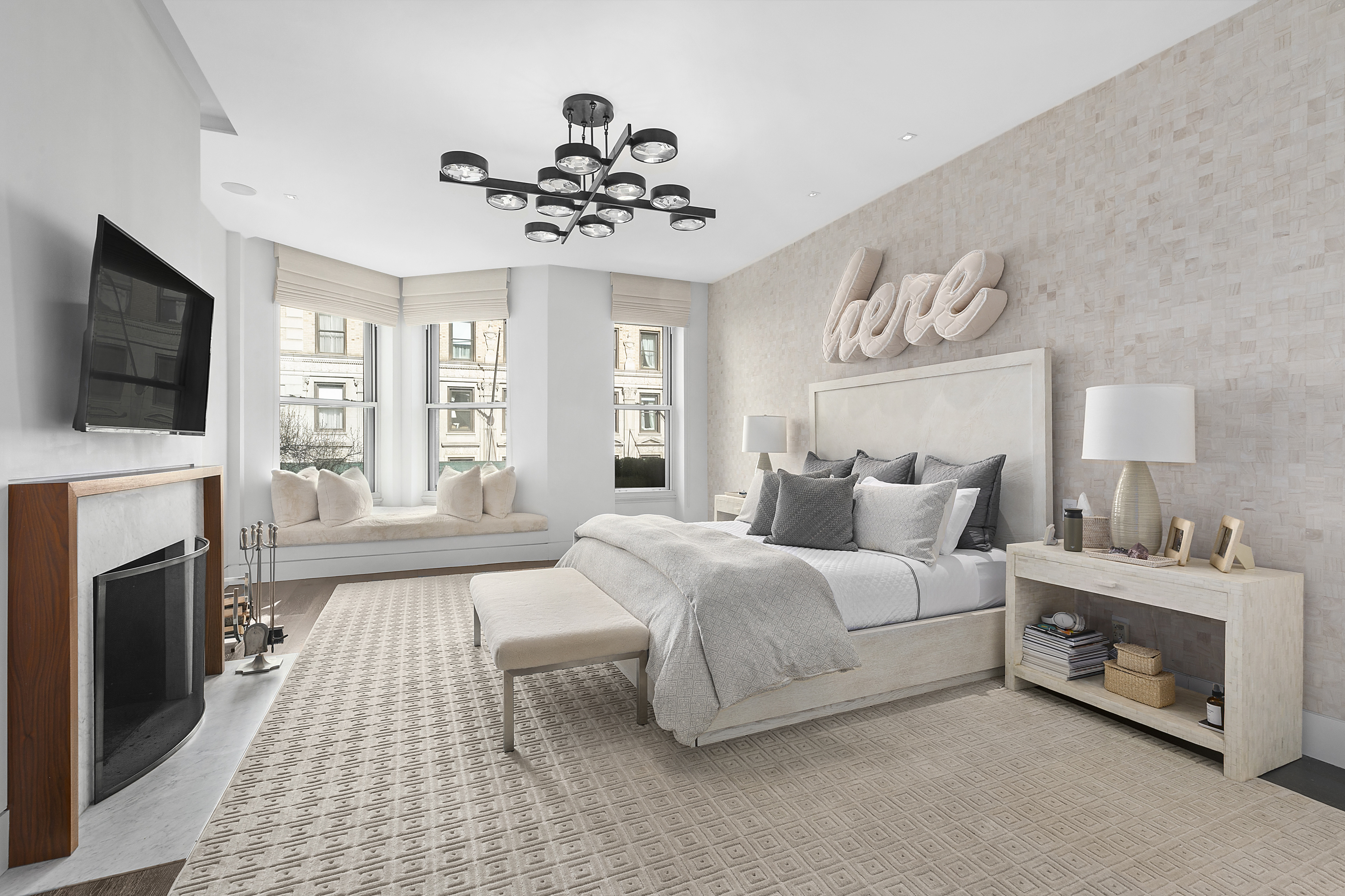 36 East 64th Street Manhattan, NY 10065 - Photo 12 of 27 a spacious bedroom with a bed and a flat screen tv