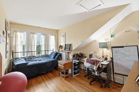 a living room with furniture floor to ceiling window and a table