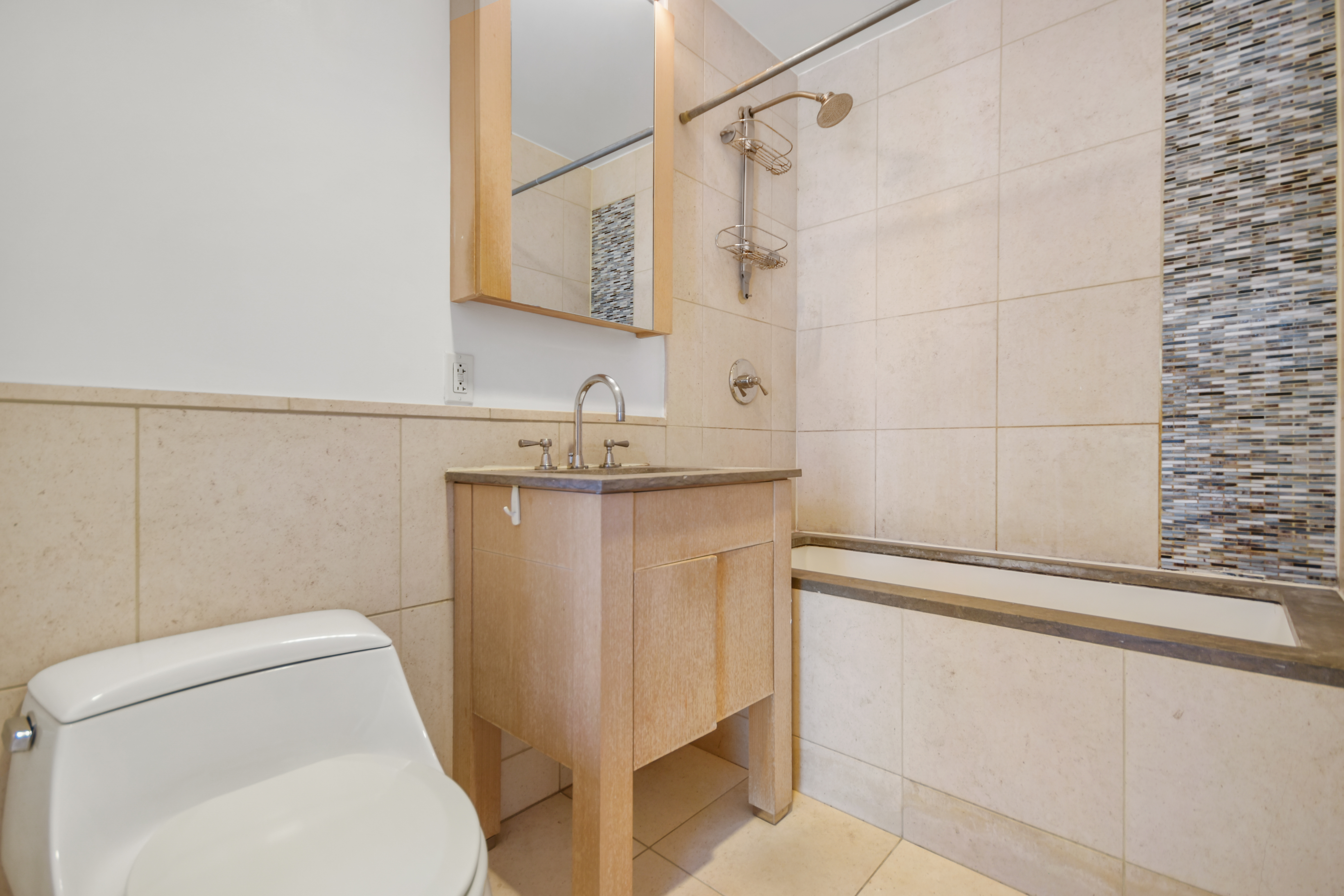 350 West 42nd Street, Unit 8H Manhattan, NY 10036 - Photo 5 of 11 a bathroom with a sink a toilet and shower