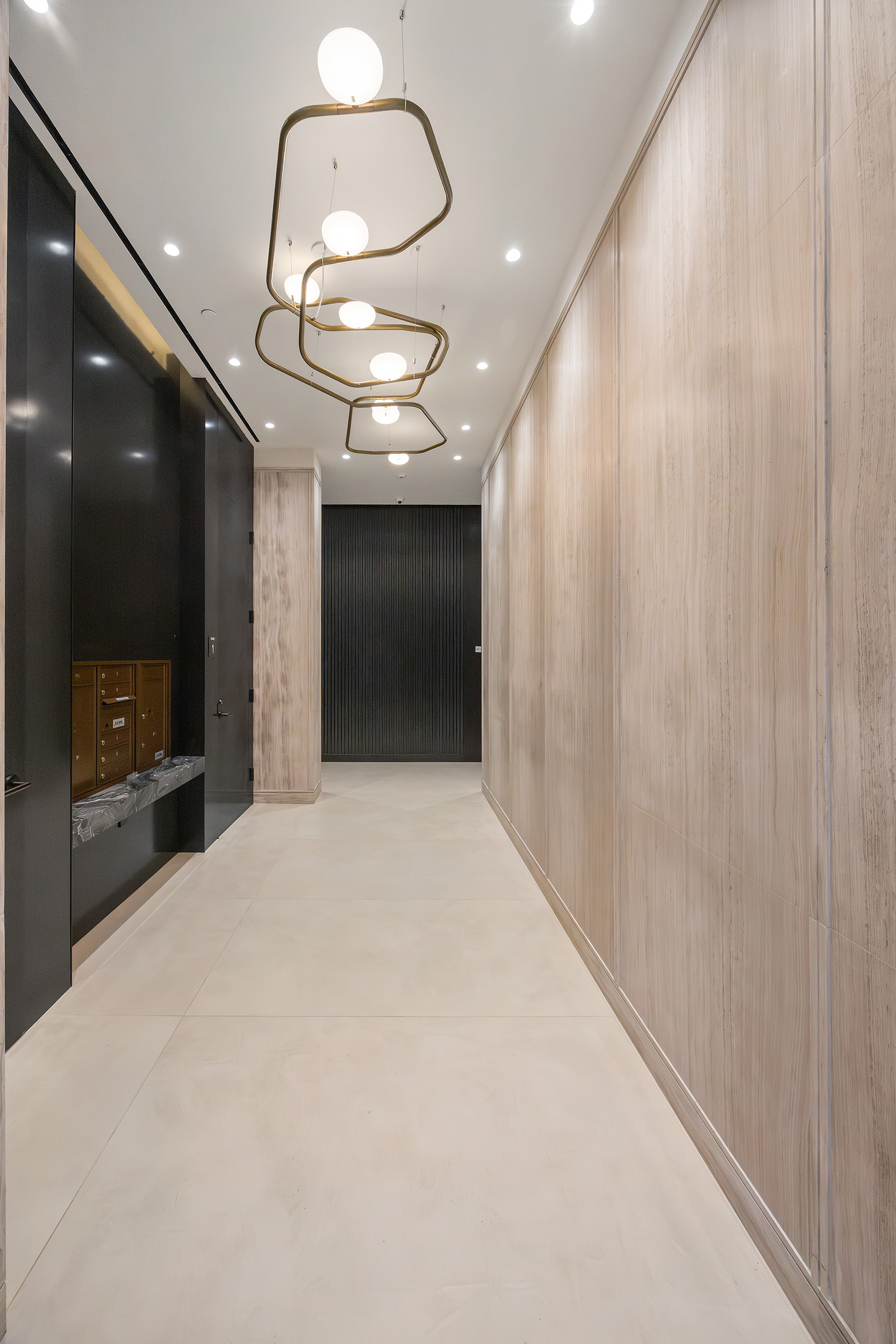 62 Reade Street, Unit 4 Manhattan, NY 10007 - Photo 19 of 20 a large room with a large mirror and a chandelier fan