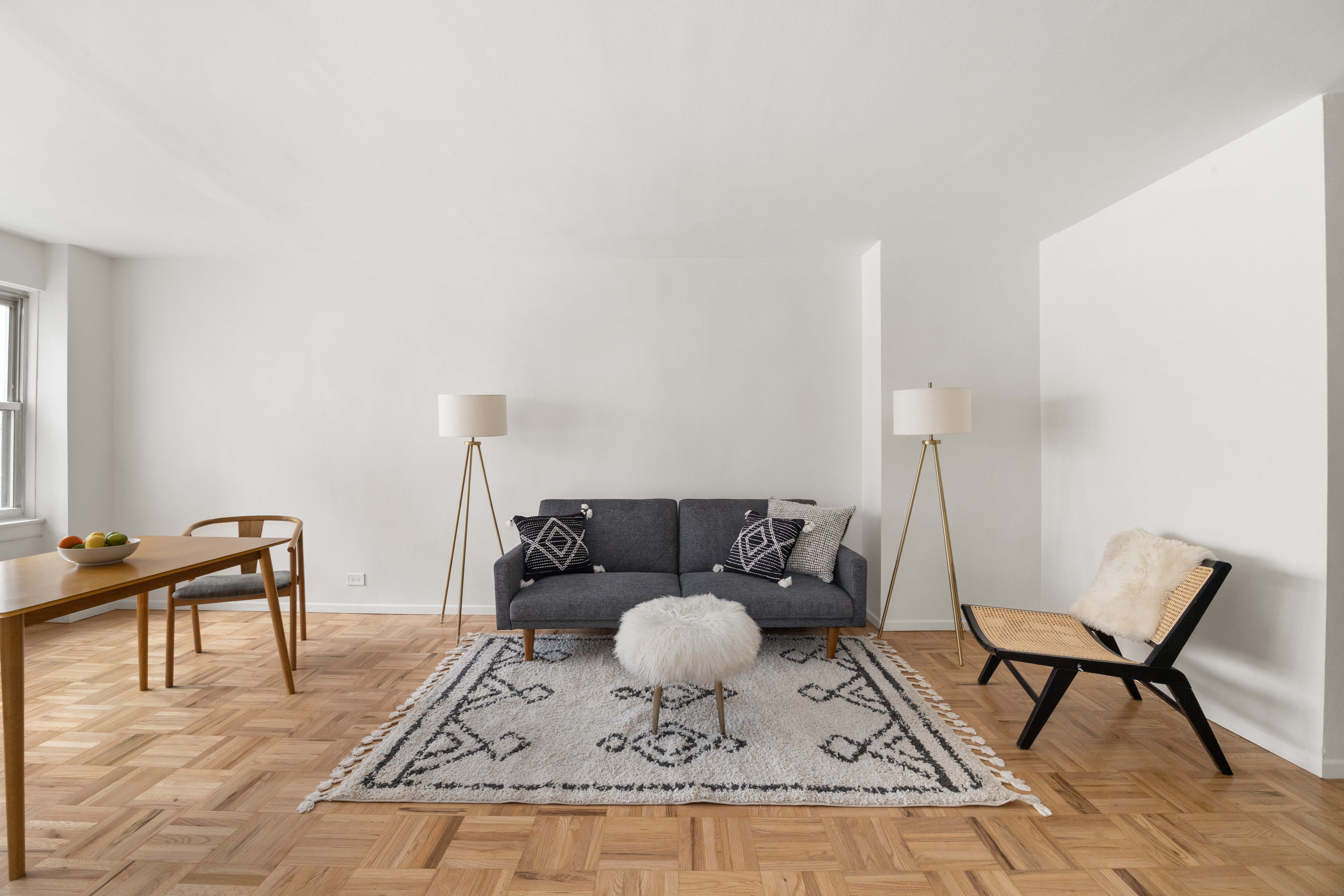155 East 38th Street, Unit 8A Manhattan, NY 10016 - Photo 3 of 8 a living room with furniture and a rug