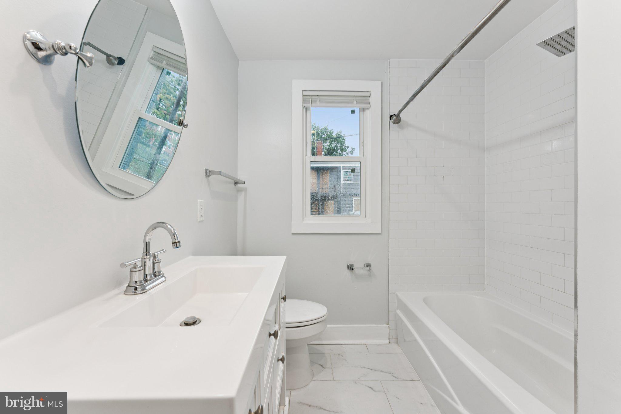 2822 28th Street Southeast Washington, DC 20020 - Photo 12 of 57 a bathroom with a sink a toilet and a bathtub