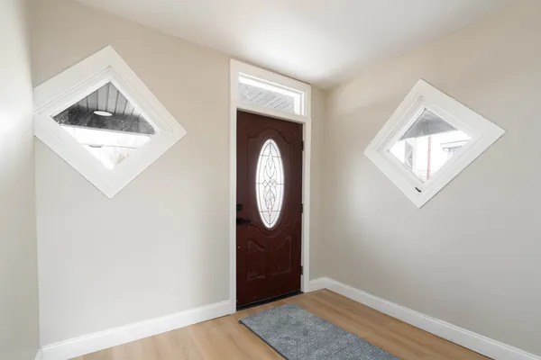 a view of an entryway with wooden floor