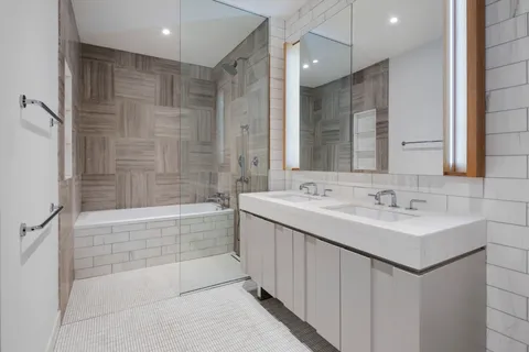 a bathroom with a sink mirror toilet and bathtub
