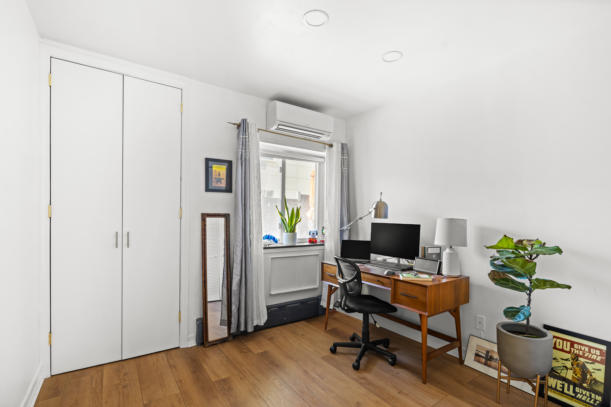 61-20 71st Avenue, Unit J1B Queens, NY 11385 - Photo 9 of 13 a view of a workspace with furniture and a window