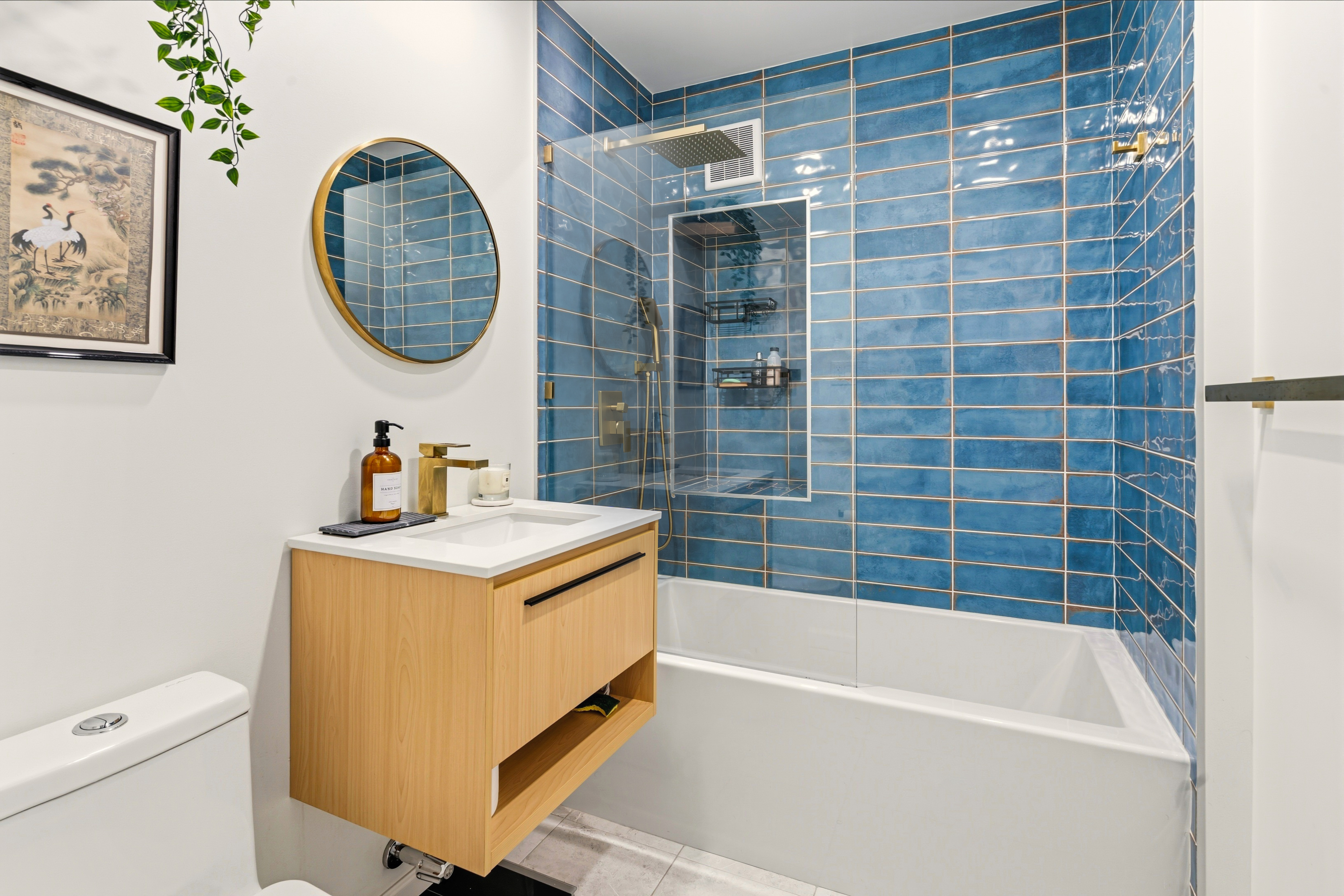 79-10 34th Avenue, Unit 2J Queens, NY 11372 - Photo 5 of 9 a bathroom with a tub a sink and a mirror