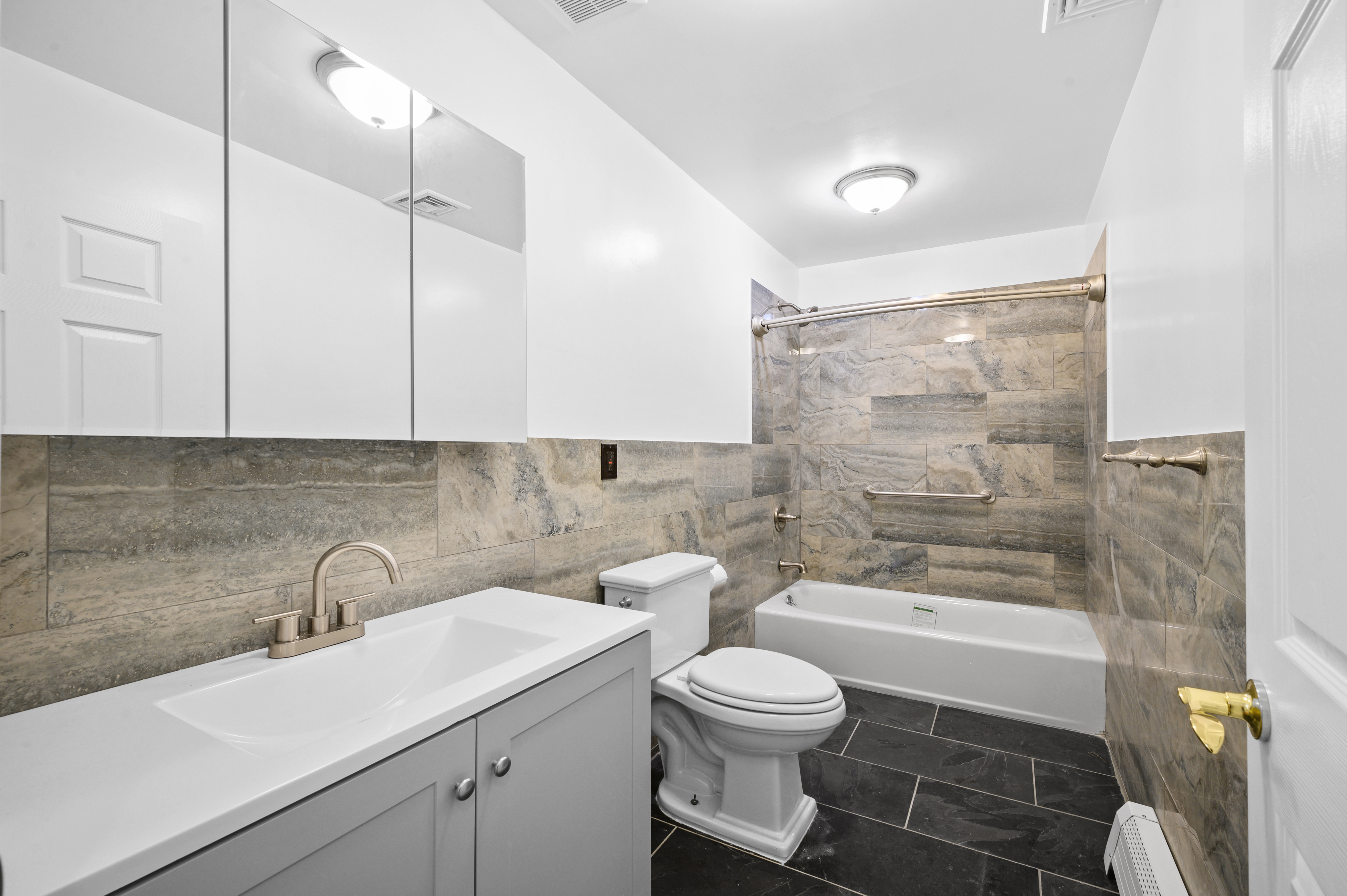 808 Lexington Avenue, Unit 1 Brooklyn, NY 11221 - Photo 6 of 8 a bathroom with a sink toilet and shower