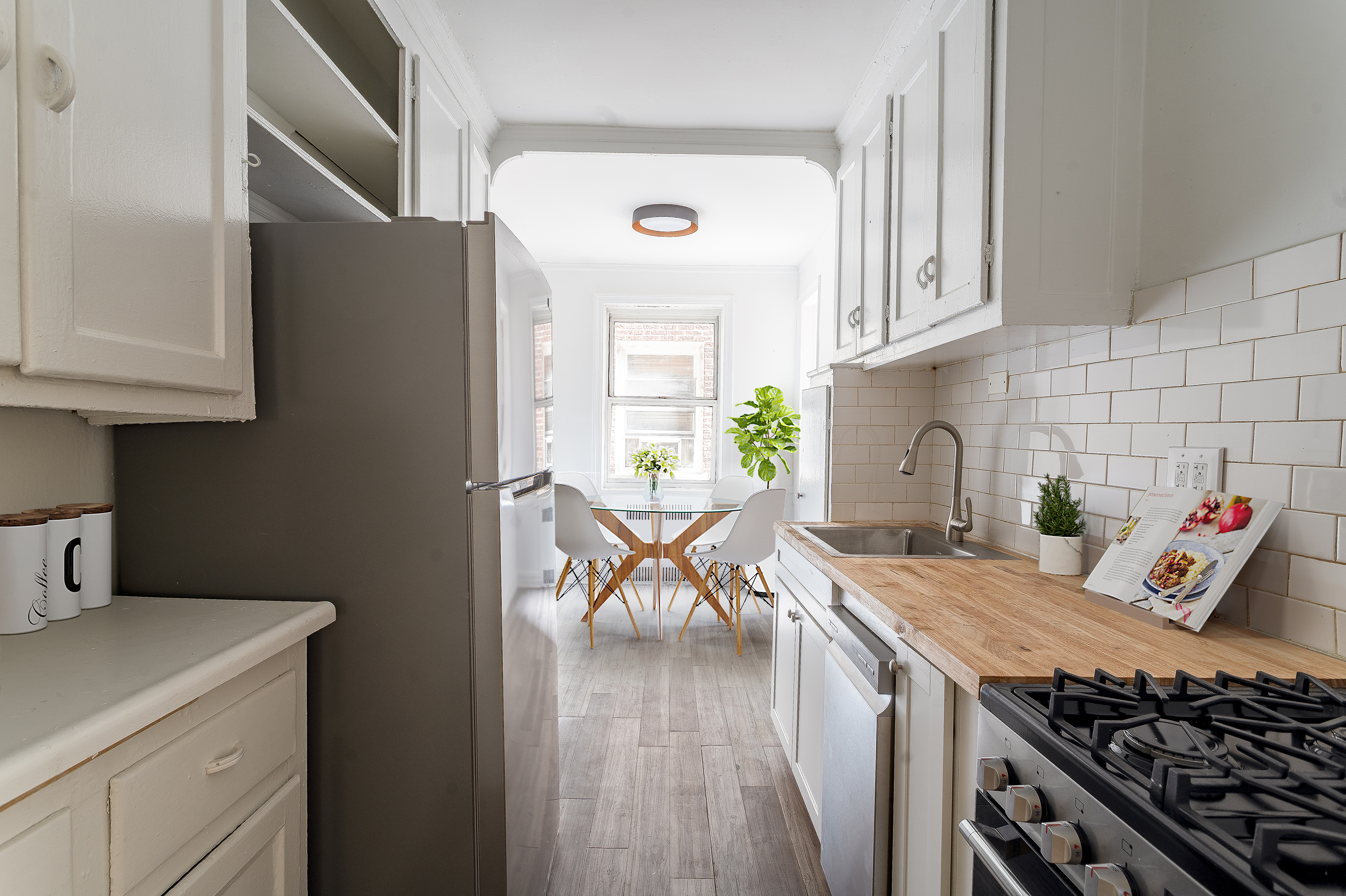 40 Tehama Street, Unit 2E Brooklyn, NY 11218 - Photo 7 of 12 a kitchen with stainless steel appliances granite countertop a stove a sink and a refrigerator