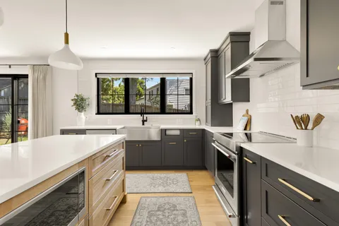 a large kitchen with a sink and a stove