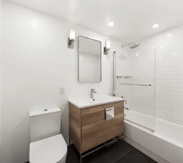 a bathroom with a sink toilet and shower