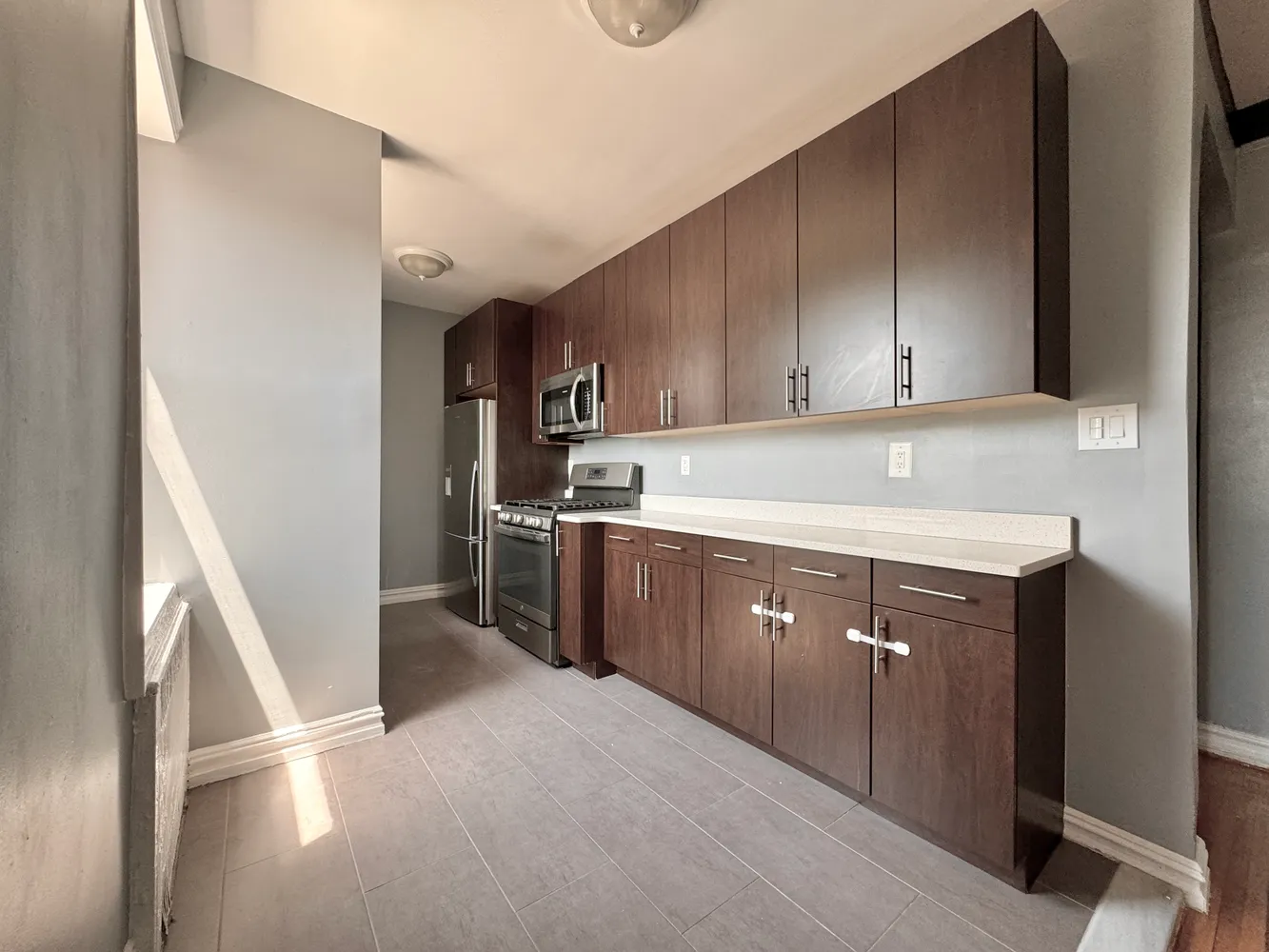 a kitchen with a sink a stove and cabinets