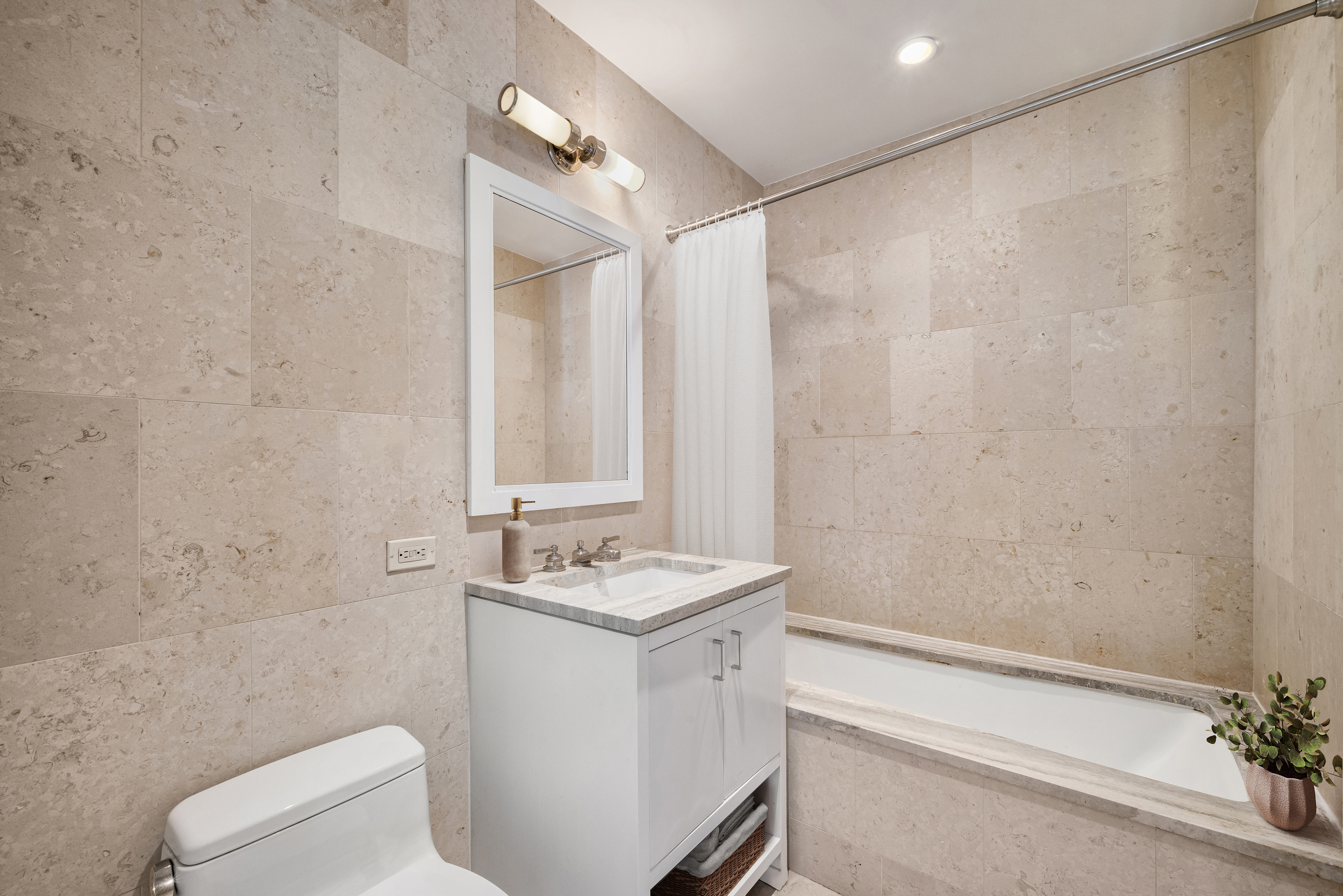 100 Riverside Boulevard, Unit 14D Manhattan, NY 10069 - Photo 4 of 13 a bathroom with a sink a toilet and shower