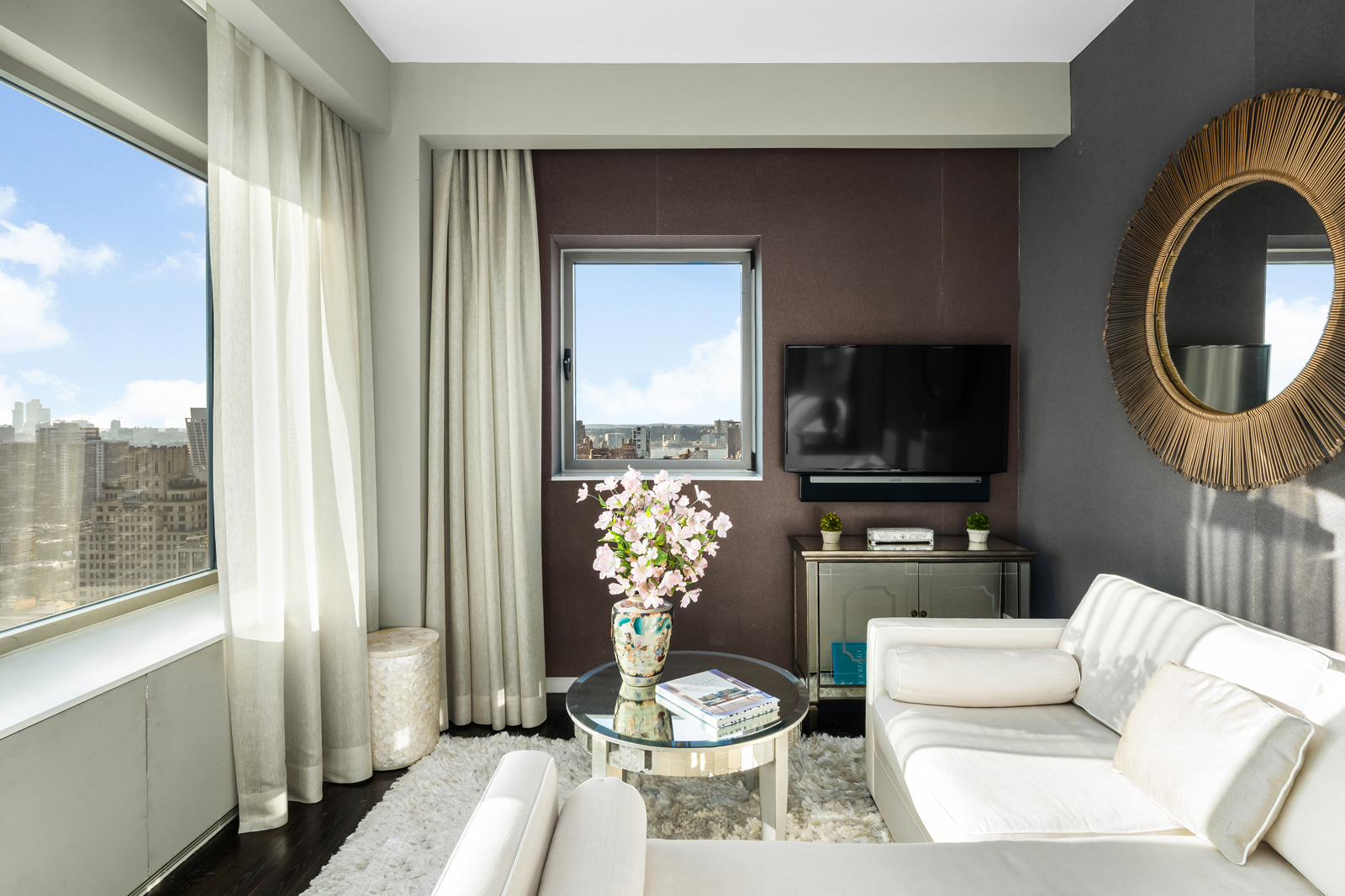 252 7th Avenue, Unit PHD Manhattan, NY 10001 - Photo 11 of 26 a living room with furniture a flat screen tv and a toilet