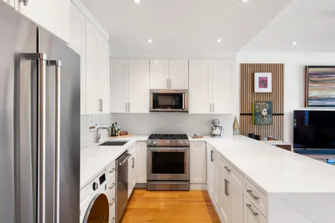 a kitchen with a sink stove and refrigerator