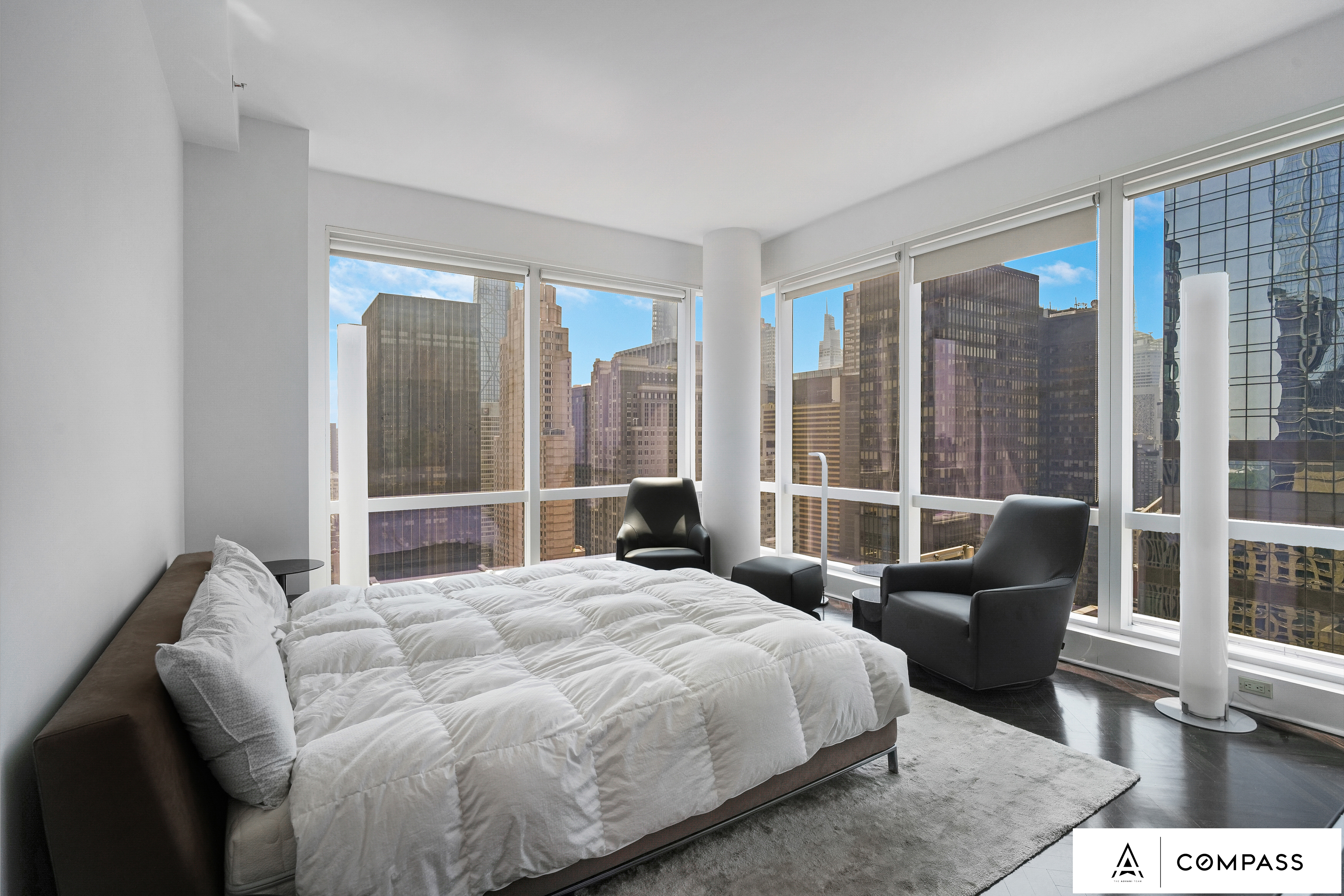 230 West 56th Street, Unit 49C Manhattan, NY 10019 - Photo 9 of 14 a bedroom with a bed and glass window